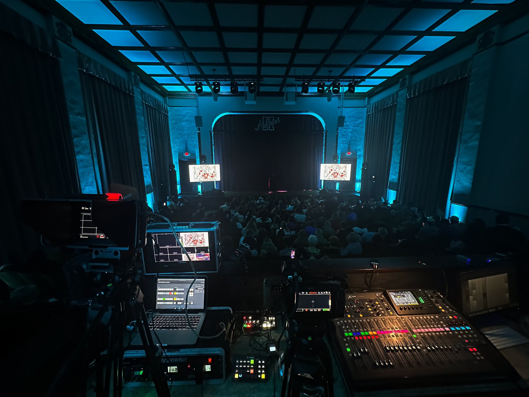 Production booth overlooking a packed live event