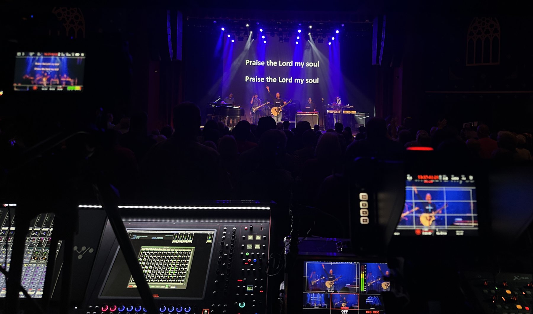 Live production booth view of a forest stage set