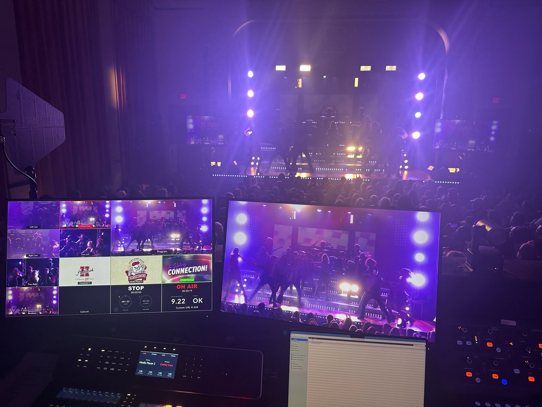 Live event production booth overlooking a lit stage